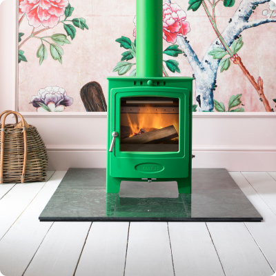 A green logburner that is lit