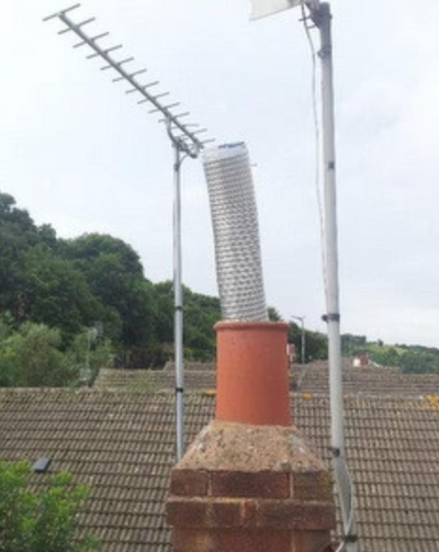 Chimney with a length of chimney liner projecting out of the top