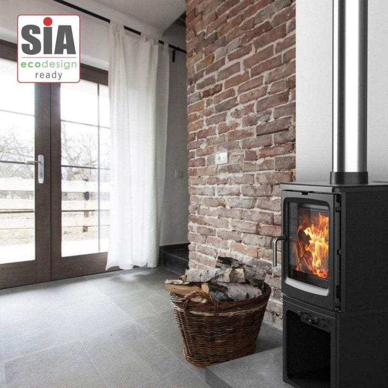 Saltfire Stoves Saltfire Peanut 5 Wood Burning Stove log store version in a room and with a silver flue pipe