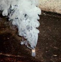 smoke pellet for testing a wood stove flue shown lit