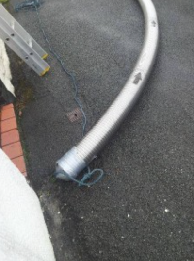 End of a chimney liner attached to a rope ready to install