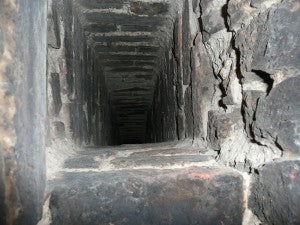 looking up inside a narrow brick chimney
