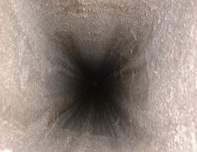 looking up inside a smooth concrete-lined chimney