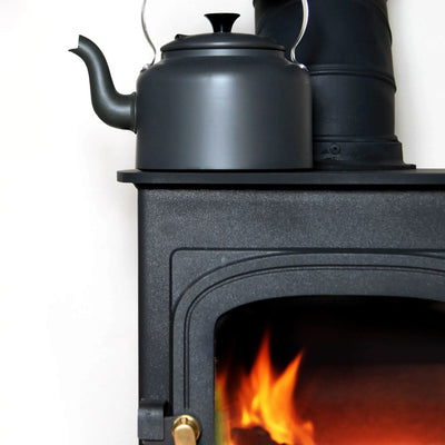 kettle on a lit wood stove