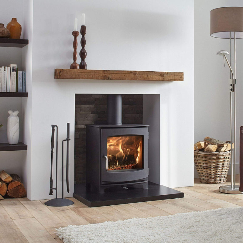 DG Stoves Dik Geurts DG Ivar 5 Wood Burning Stove 5kW in a recess with rug in front