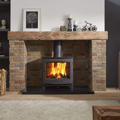 DG Stoves Ivar 8 Dik Geurts DG Ivar 8 Wood Burning Stove 8kW in a brick recess in a room with lit fire