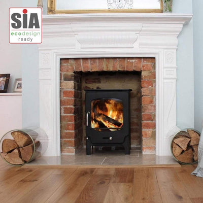 Saltfire Stoves Saltfire ST-X5 Multifuel Wood Burning Stove 5kW in a brick recess with a wooden mantlepiece